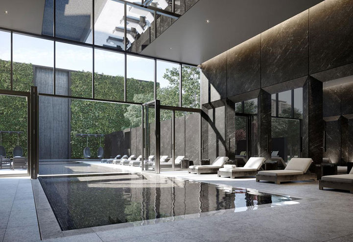 Indoor/Outdoor Pool with Sun loungers at Untitled Toronto Condos