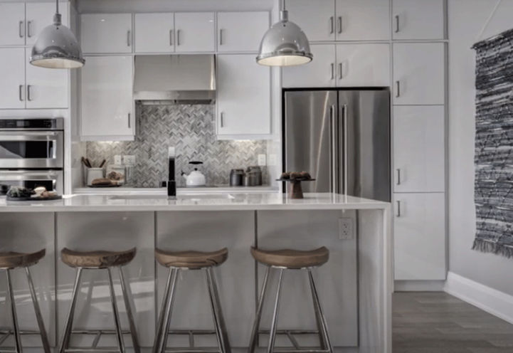 Kitchen with Stainless Steel Appliances and Island with Stools